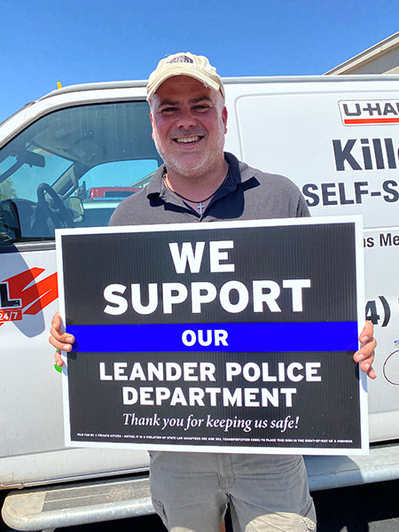 Travis Griffin with sign supporting Leander Police Department